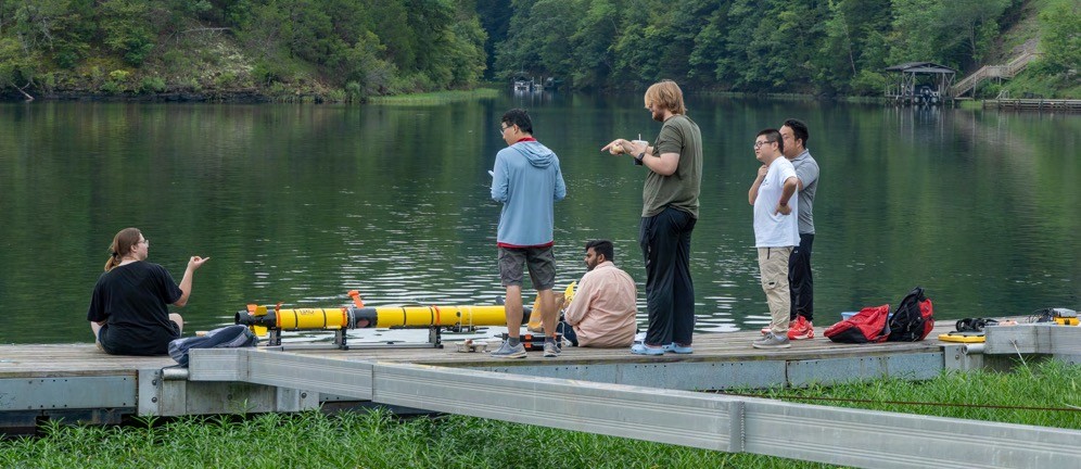 The muNet Laboratory team with an L3Harris Iver3 EcoMapper, fitted with a Subnero smart modem.