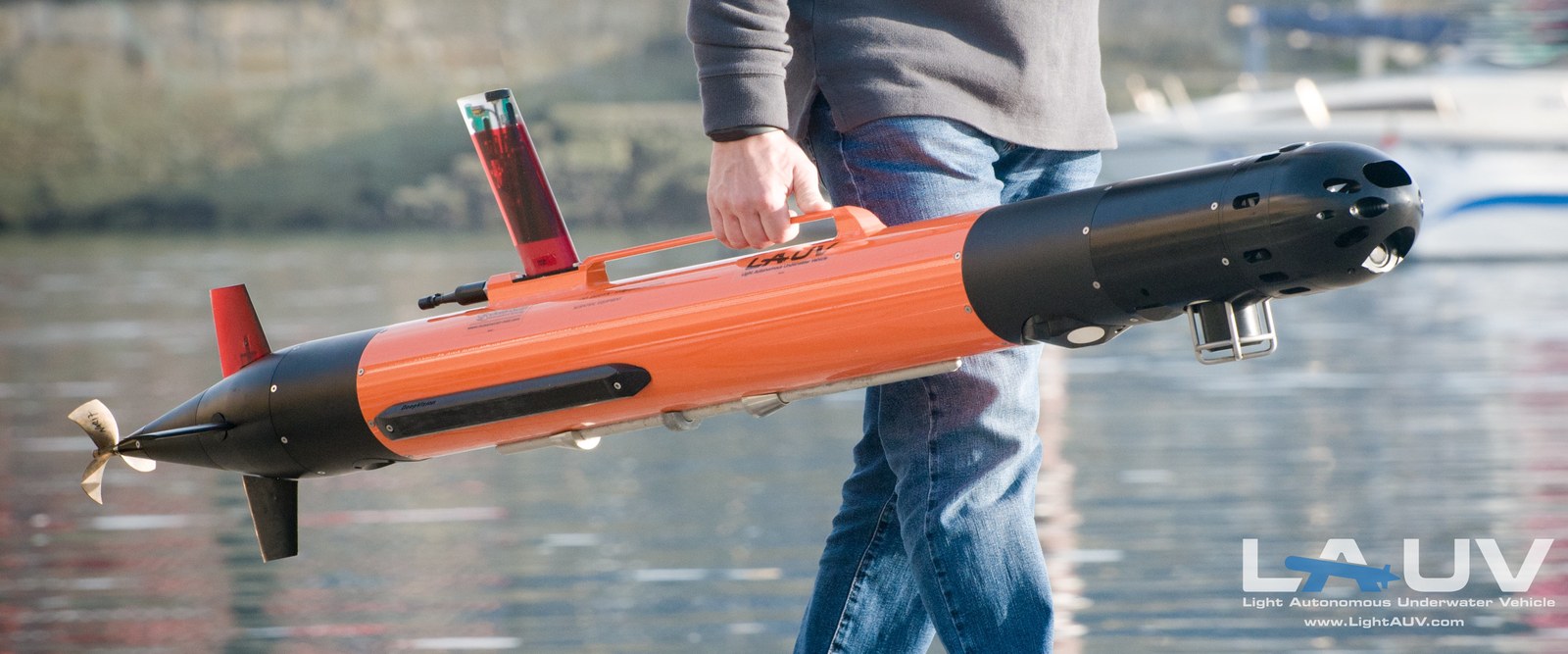 The LAUV being hand carried at the waterside, a man-portable autonomous underwater vehicle.
