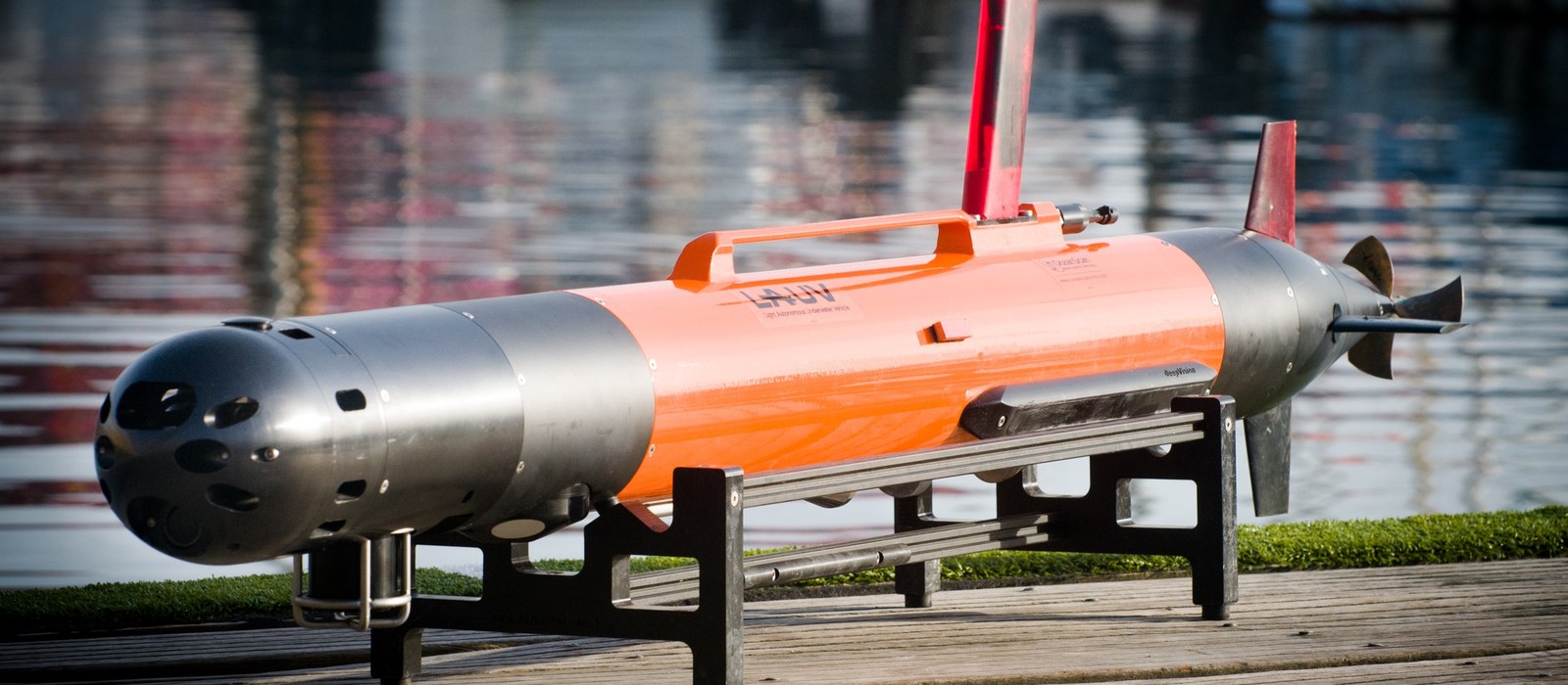 An OceanScan MST LAUV on its stand at the dockside, ready for deployment.